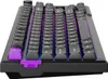 A close-up, angled view of a black gaming keyboard with purple accent keys and RGB lighting. Produktbild-Vorschau