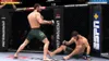 A video game screenshot showing two MMA fighters in a ring. One fighter is standing and appears to be throwing a punch, while the other is on the ground. Náhled obrázku produktu