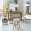 A living room scene with a console table, lamps, baskets, and stools. Podgląd zdjęcia produktu