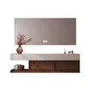 A modern bathroom vanity with a mirror and decorative items. Anteprima dell’immagine prodotto