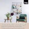 A living room scene with a wall grid, a chair, and a side table. Produktbild-Vorschau