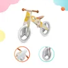 A wooden balance bike is shown against a white background with abstract pastel shapes. Náhľad obrázku produktu