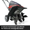 A close-up view of the tilling mechanism and wheels of a garden tiller, with a white background and text overlay. Produktbild-Vorschau