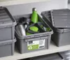 Storage boxes on a shelf, one is open and filled with items. Anteprima dell’immagine prodotto