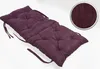 A long, tufted cushion in a dark violet color, shown on a white background. A circular inset shows a close-up of the fabric texture. Produktbild-Vorschau