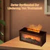 A decorative fireplace humidifier with a flame effect sits on a wooden table, with a plant and a framed picture in the background. Produktbild-Vorschau
