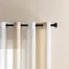Close-up of sheer curtains hanging on a curtain rod. Produktbild-Vorschau
