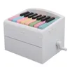 A white piano-shaped calendar with colorful keys. Produktbild-Vorschau