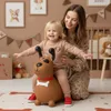A mother and child are playing in a nursery with a bouncy dog toy. Podgląd zdjęcia produktu