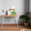 An aroma diffuser is placed on a wooden desk with decorative items. Voir les images du produit