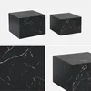 A collage of images showing two cube-shaped side tables with a black marble-like pattern. Anteprima dell’immagine prodotto