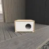 A white and wood cat house with a circular opening is placed on a wooden deck. Produktbild-Vorschau
