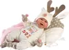 A baby doll lying on a pink blanket and a deer-themed pillow. Podgląd zdjęcia produktu