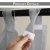 Close-up of a hand attaching a grey sheer curtain to a curtain rod using velcro tabs. Anteprima dell’immagine prodotto