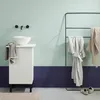 A modern bathroom scene with a sink, cabinet, and towel rack. Anteprima dell’immagine prodotto
