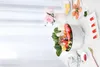 A white electric pot filled with fresh vegetables and mushrooms, arranged on a marble surface with decorative flowers and plates of food in the background. Produktbild-Vorschau