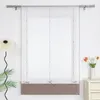 A white sheer curtain with a brown hem is displayed against a white wall. A lamp and some greenery are visible on the left, and a vase of tulips sits on a nightstand on the right. Produktbild-Vorschau
