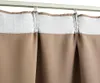 Close-up view of taupe curtains hanging from a white curtain rod. Náhľad obrázku produktu