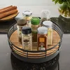 A rotating spice rack with various spice jars on a countertop. Anteprima dell’immagine prodotto