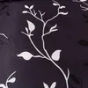 A close-up of a dark fabric with a white floral pattern. Náhled obrázku produktu