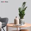 A living room scene with a chair, coffee table, plant, and vase. Anteprima dell’immagine prodotto