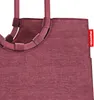 A close-up view of the top part of a maroon shopping bag, showing the handles and the brand tag. Náhľad obrázku produktu