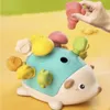 A hand is placing a pink piece into a toy hedgehog. Náhľad obrázku produktu