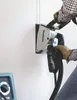 A person is using a Makita wall chaser to cut a groove in a white wall. Podgląd zdjęcia produktu