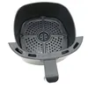 A close-up, top-down view of the interior of an air fryer basket and its housing. Produktbild-Vorschau