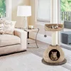 A cat tree is placed in a living room next to a sofa and a side table with a lamp. Produktbild-Vorschau