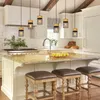 A modern kitchen with a large island, pendant lights, and bar stools. Anteprima dell’immagine prodotto