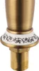 Close-up of the base of a faucet with decorative ceramic detailing. Náhled obrázku produktu