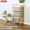 A bamboo laundry sorter with three fabric baskets, placed in a room with a plant and wooden floor. Anteprima dell’immagine prodotto