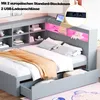 A gray bed with storage drawers and a headboard featuring shelves and LED lighting. Produktbild-Vorschau