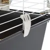 A close-up view of a white plastic clip attached to the wire bars of a pet cage. Podgląd zdjęcia produktu