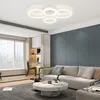 A modern living room with a sectional sofa, coffee table, and a large window. Voir les images du produit
