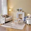 A living room scene featuring a sofa, coffee table, fireplace, and side tables. Produktbild-Vorschau