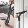 Split image showing a person using a vacuum cleaner handle and nozzle in two different scenarios: one on a wooden surface and another on a white radiator. Produktbild-Vorschau