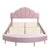 A pink upholstered bed frame with a scalloped headboard and a curved footboard, shown without a mattress. Produktbild-Vorschau