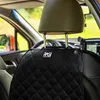 Interior of a car, focusing on a black car seat protector with a logo. Produktbild-Vorschau