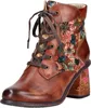 A single brown leather boot with a floral textile pattern on the side and heel.