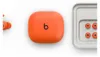 A top-down view of orange Beats by Dr. Dre Powerbeats Fit wireless earbuds and their charging case, along with a tray of replacement ear tips. Náhľad obrázku produktu