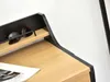 A close-up view of a minimalist desk with sunglasses on a shelf and a magazine on the surface. Náhľad obrázku produktu