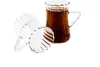 Two clear glass tea glasses, one filled with dark tea, against a white background. Voir les images du produit