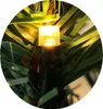 A close-up of a Christmas light on a pine garland. Produktbild-Vorschau