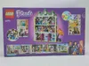 The back of a LEGO Friends Emma's Art School playset box, showing various scenes and mini-doll figures. Podgląd zdjęcia produktu