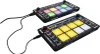 Two DJ controllers are shown connected by cables, against a white background. Produktbild-Vorschau