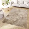A modern living room with a sofa, coffee table, armchair, and a large rug. Produktbild-Vorschau