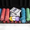 A close-up view of a poker set laid out in its case, showing poker chips, playing cards, and dice. Podgląd zdjęcia produktu