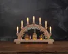 A wooden Christmas arch with illuminated houses and candle-like lights. Podgląd zdjęcia produktu